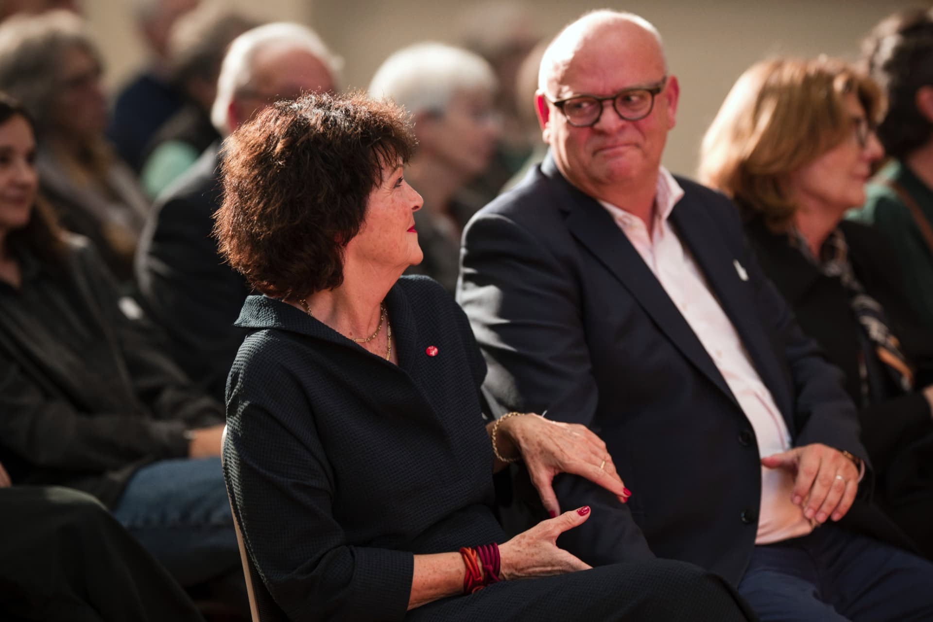 Two guests seated side by side following the assembly
