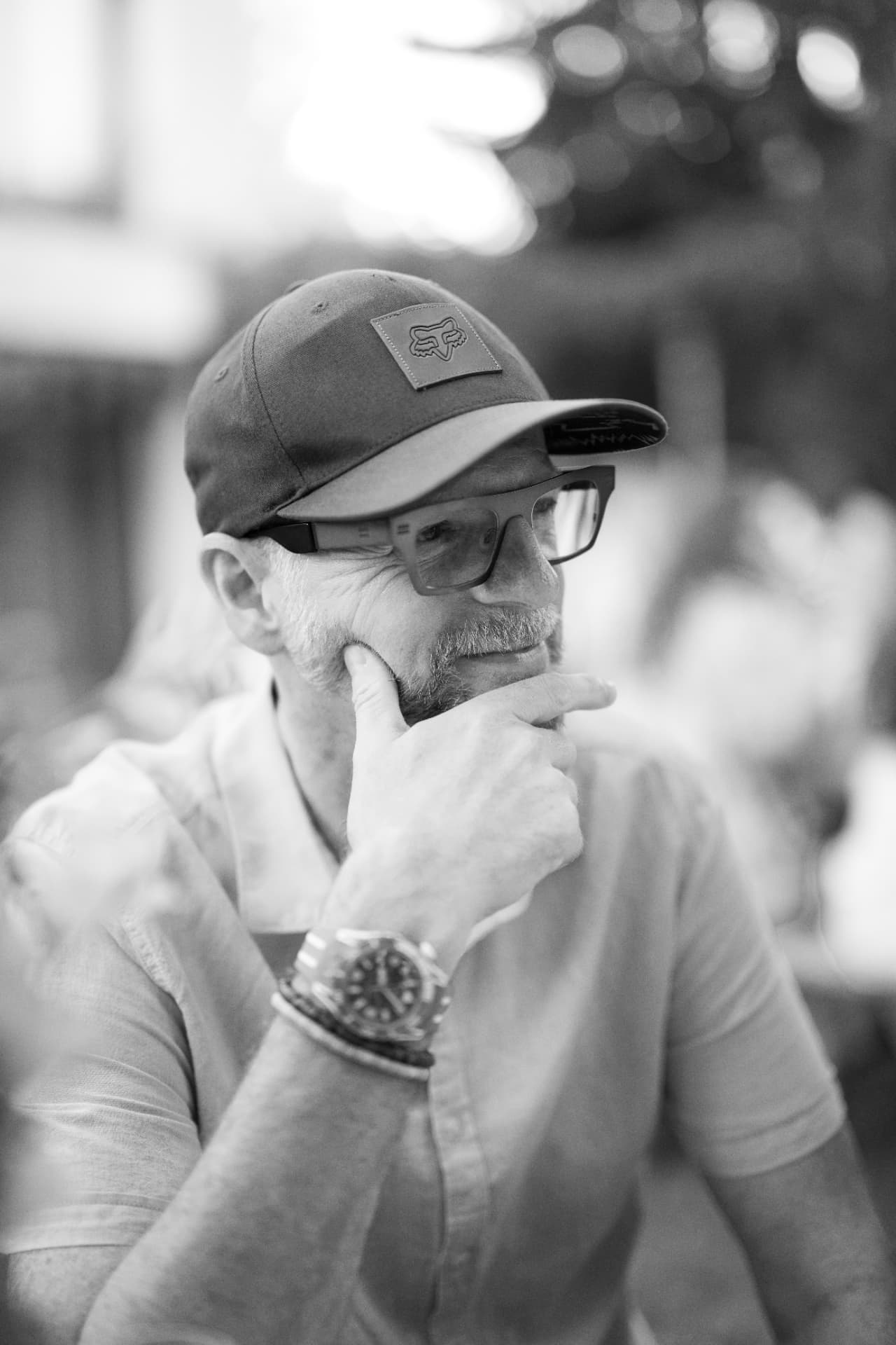 Gast mit Cap und Brille im Halbprofil